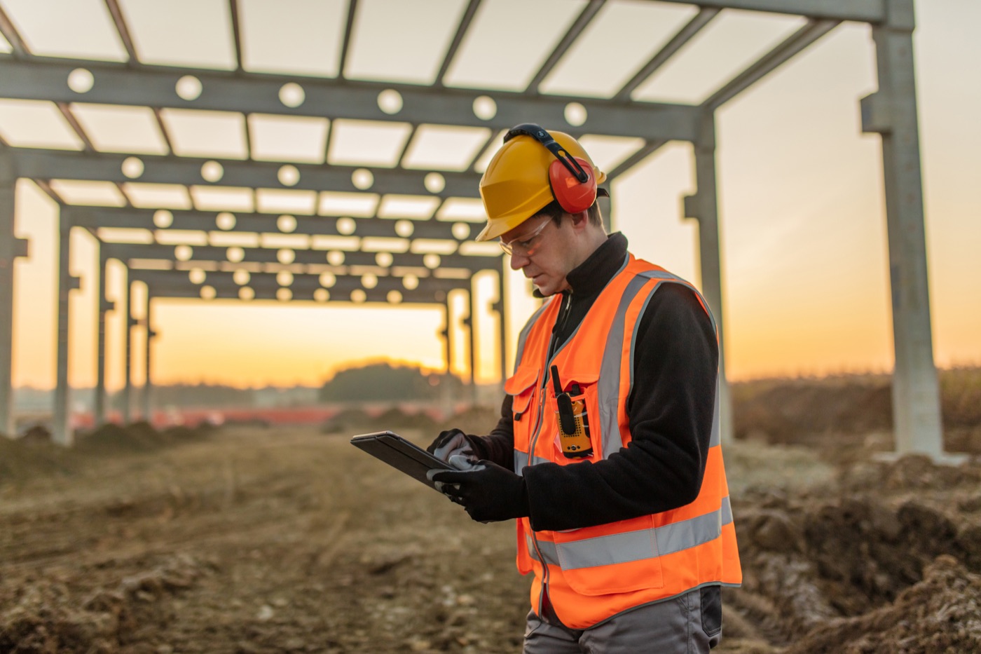 Site engineer with a tablet at a construction site