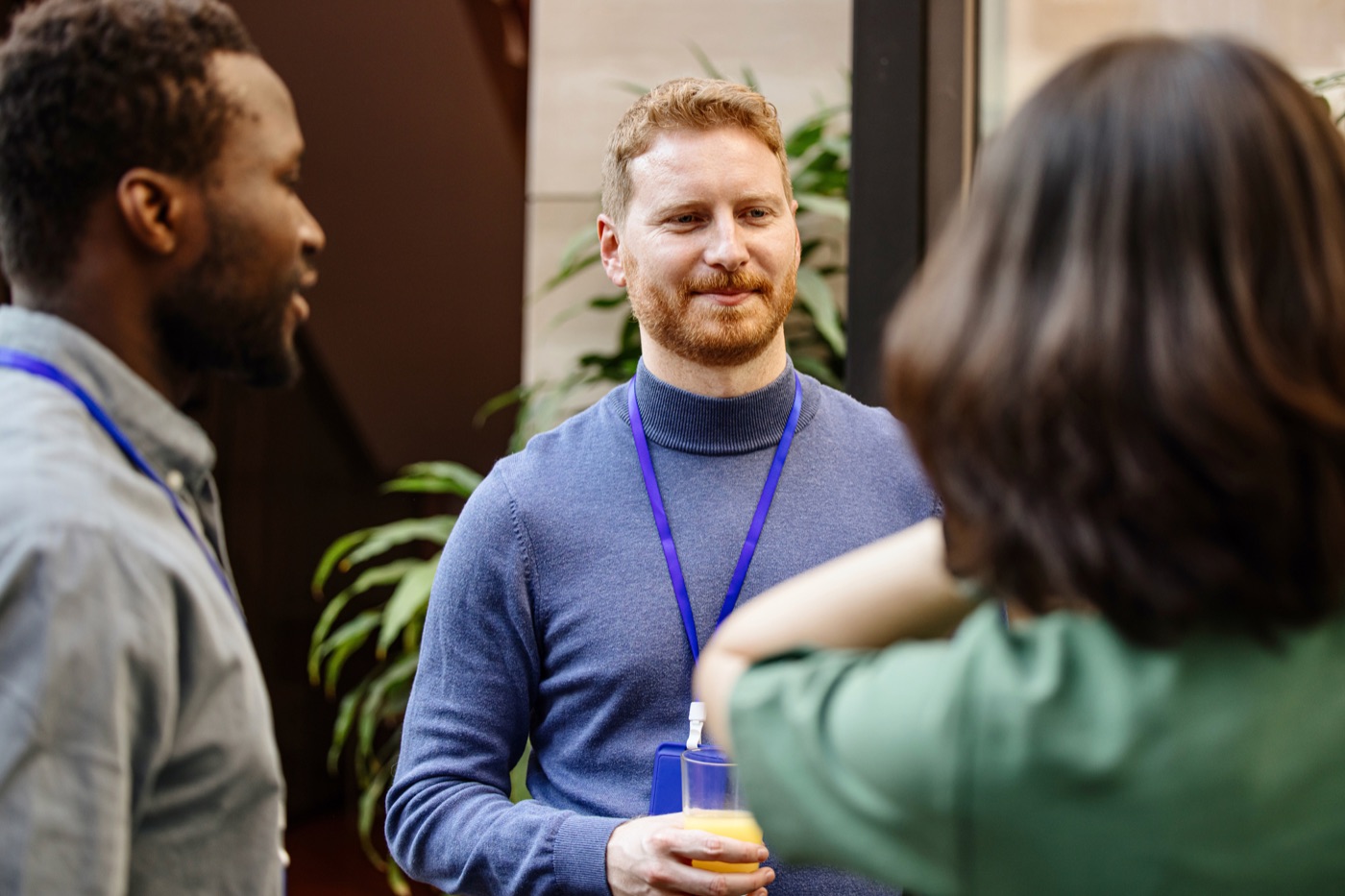 Colleagues wearing lanyard badges in conversation
